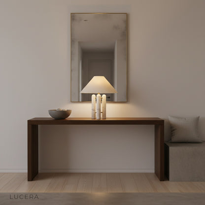 Ambient evening shot of Oblate Table Lamp casting warm glow on minimalist bedroom nightstand