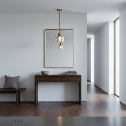 Tucana glass cube pendant light hanging above marble dining table