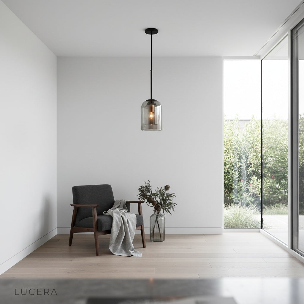 Theodora double pendant light casting ambient glow in a minimalist bedroom at dusk