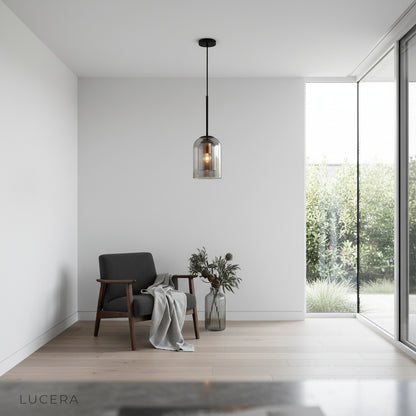 Theodora double pendant light casting ambient glow in a minimalist bedroom at dusk