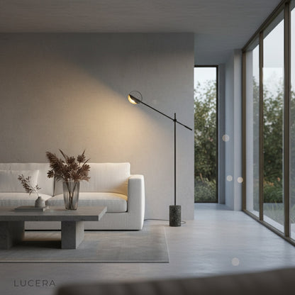 Nighttime lifestyle shot of Memento Floor Lamp illuminating a minimalist home office desk
