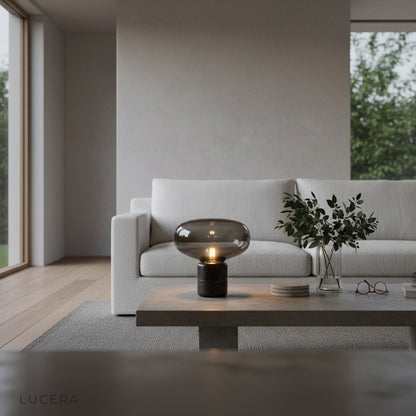 Elegance Table Lamp on a minimalist home office desk, tinted glass diffusing warm light over open notebook and pen