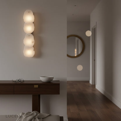 Esker wall lamp as a statement piece in a chic dining room with warm glow