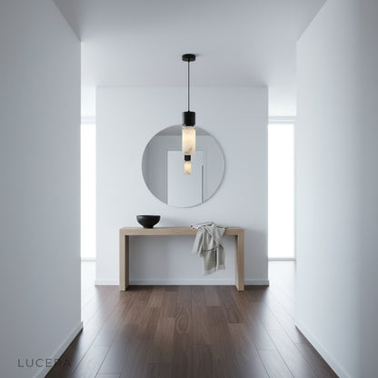 Hematite pendant light glowing in a reading nook with books and armchair, casting soft shadows on the wall