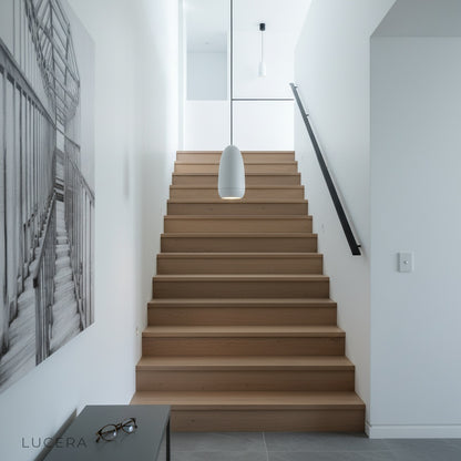 nighttime lifestyle view of capsule pendant lights adding depth to a contemporary living room