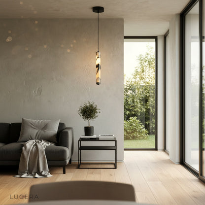 hypnotic marble pendant light suspended in a contemporary lounge with floor-to-ceiling windows at dusk