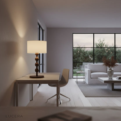 Boreal Table Lamp illuminated at dusk on console table in rustic living room with soft shadows