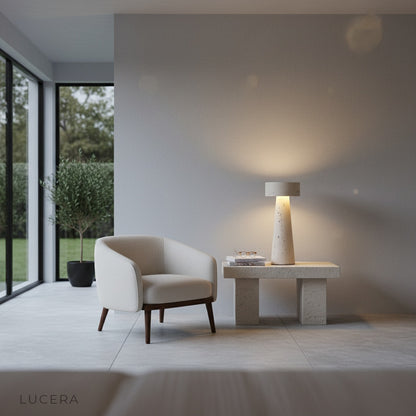 Warm glowing Xenodochium lamp on bedside table in serene minimalist bedroom at night