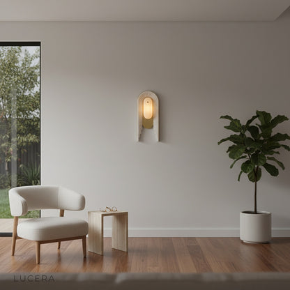sculptural Fulgid wall lamp casting warm light in a minimalist hallway