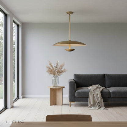 nighttime lifestyle shot of Ravish sculptural disc pendant light illuminating modern hallway
