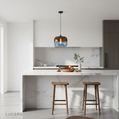 Minerva pendant light hanging above kitchen island in bright contemporary space