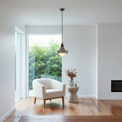 Warm ambient light from Eclipse Pendant Light illuminating a minimalist bedroom corner