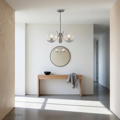 sculptural glass globe chandelier with reflective chrome finish in stylish lounge at night