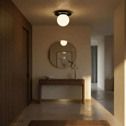aesthetic corner view of Bijou ceiling light with glass ball reflecting warm LED light