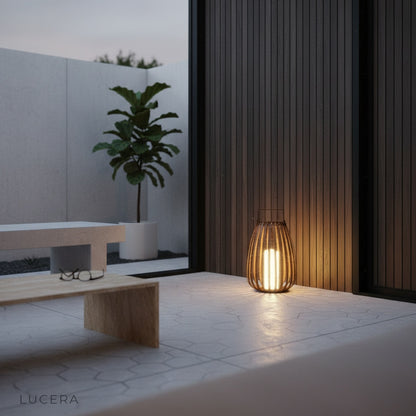 cozy rattan outdoor lamp casting warm light in backyard corner