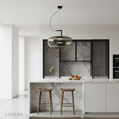 Yardang pendant light suspended over marble countertop in elegant modern kitchen setting