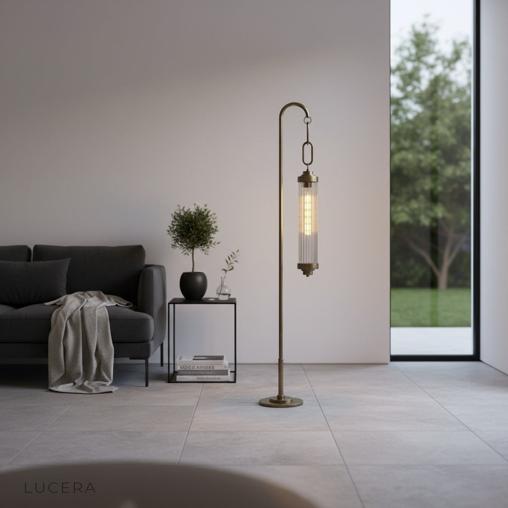 Sacrament Floor Lamp glowing beside armchair in minimalist bedroom at night