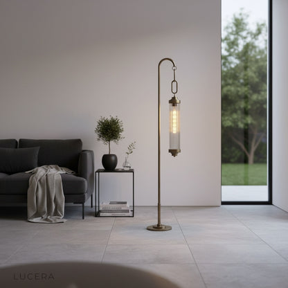 Sacrament Floor Lamp glowing beside armchair in minimalist bedroom at night