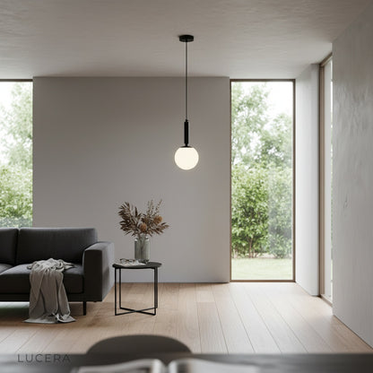 Yvaine pendant light as focal point in stylish reading nook with soft lighting