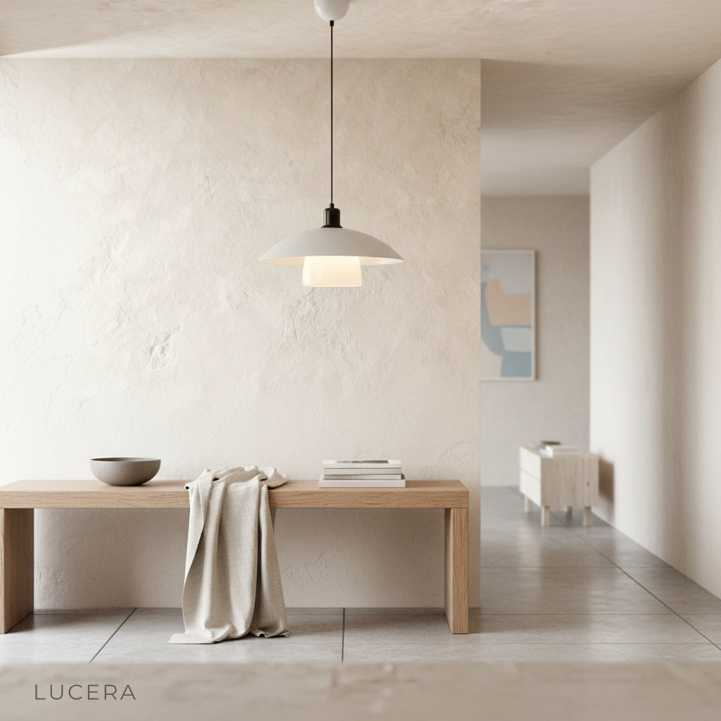 Eburnean pendant light in dark interior with warm light and shadow play on wall