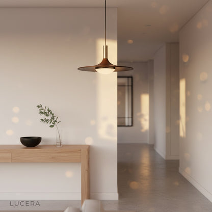 Juju pendant light in a contemporary entryway with soft glow and architectural backdrop