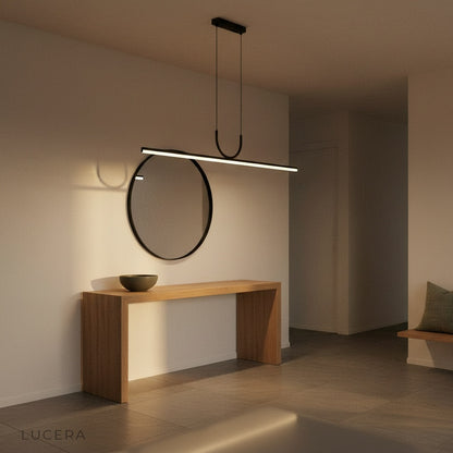 Nighttime lifestyle shot of Honeysuckle pendant light glowing softly in a cozy dining nook with dark walls
