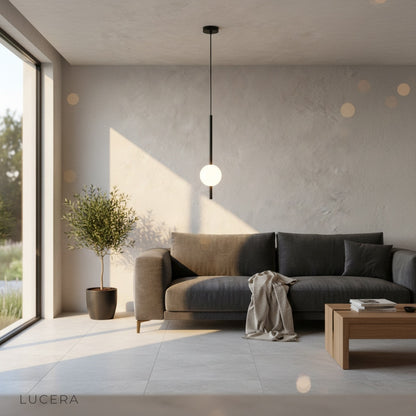 Overhead view of pendant light illuminating a styled coffee table vignette