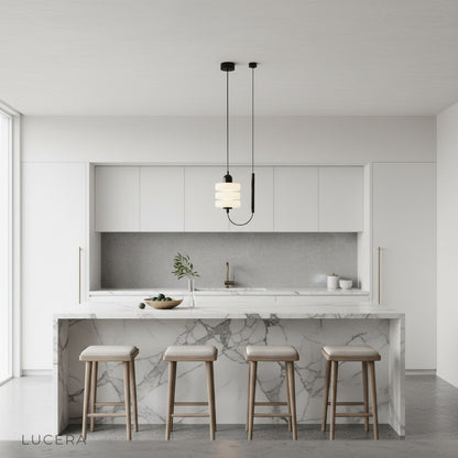 Bastian pendant light in a hallway with black iron frame contrasting against light walls and wood floor