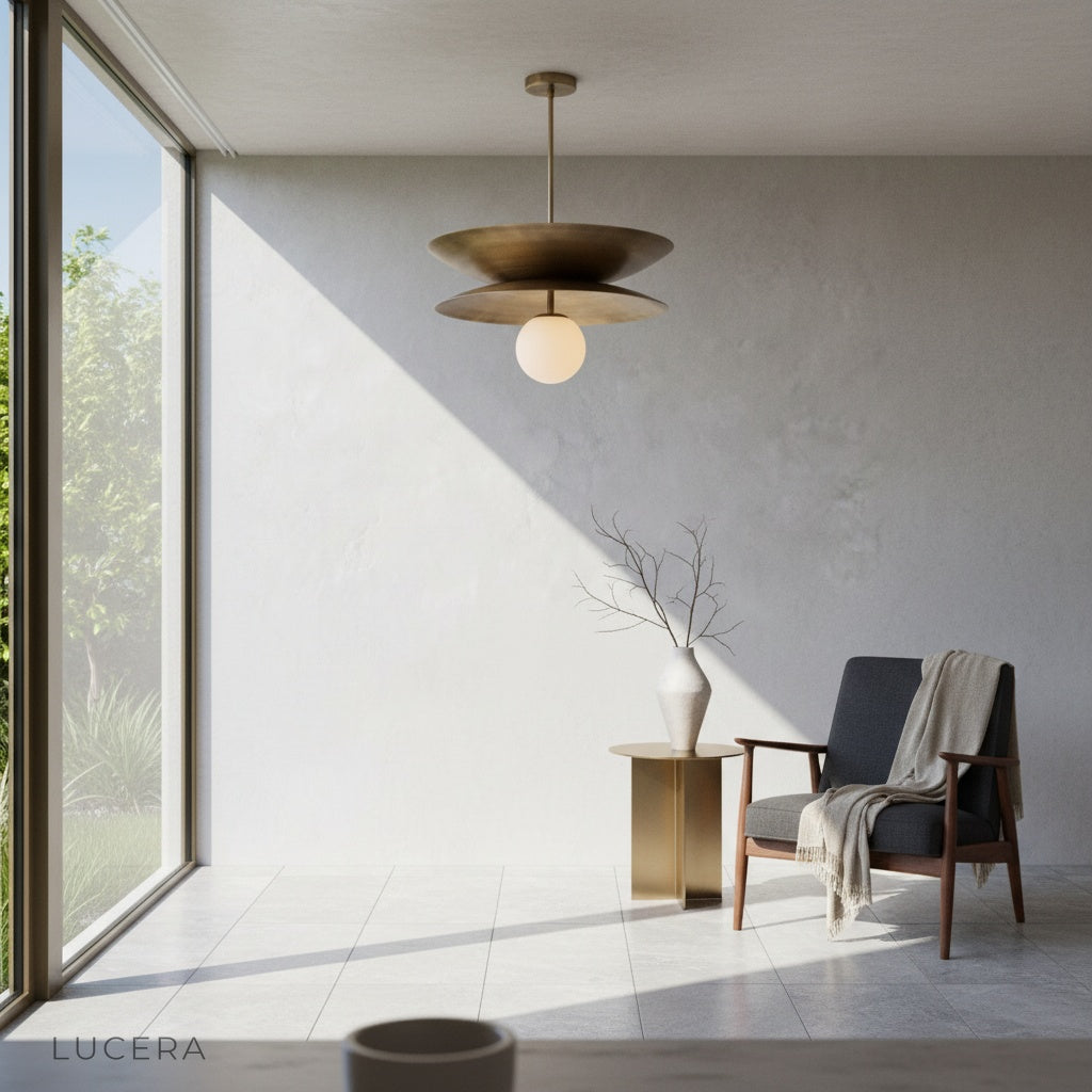 Tremulous pendant light over rustic wooden dining table with soft ambient glow and brass accents