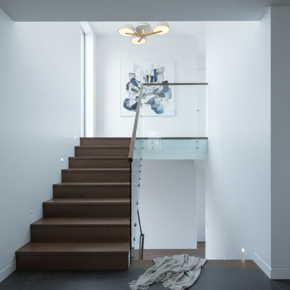Virescent ceiling light casting ambient evening glow in a cozy bedroom with warm wood furniture