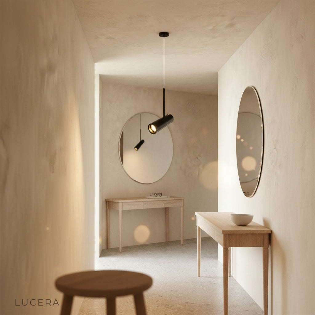 Bistre aluminum pendant light suspended at varying heights above rustic wooden table in bright room