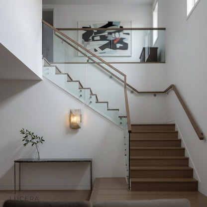 Haut-Médoc wall lamp in stairwell corner with layered stone panels glowing warmly