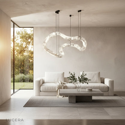 Fenwick chandelier casting ambient light over a cozy seating area in a stylish loft