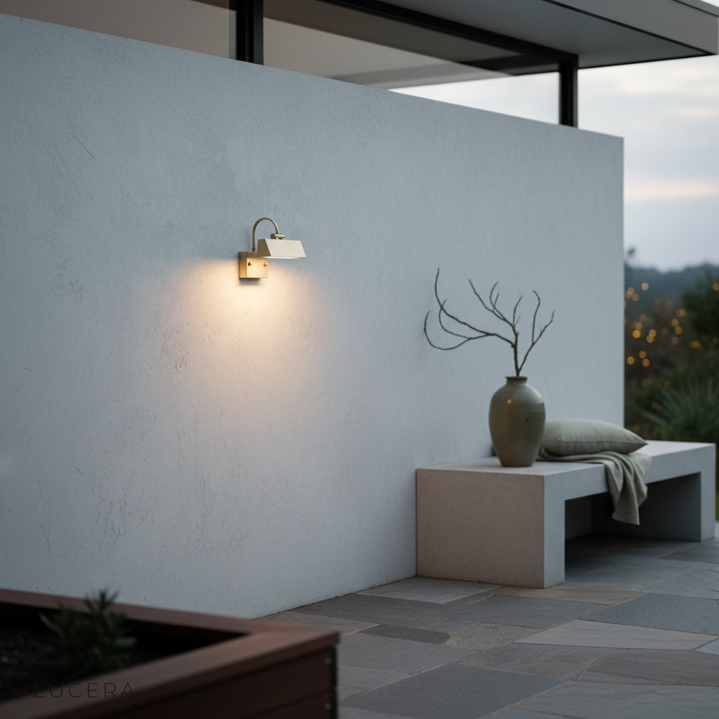 Quiete outdoor sconce glowing against a wooden slat wall in a cozy backyard