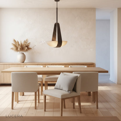 Talus pendant light hanging low over a kitchen island with warm evening lighting