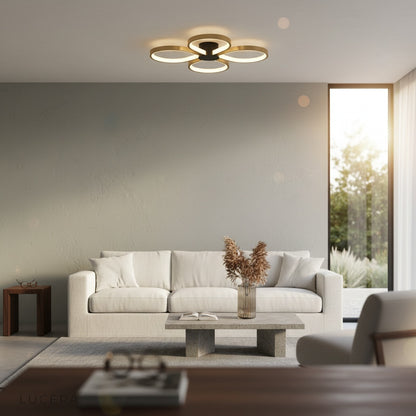 Lucera brass ceiling light glowing warmly in a modern bedroom with neutral tones