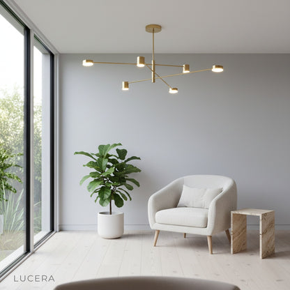 Nighttime lifestyle shot of Winsor Blue Chandelier casting ambient light in a modern bedroom