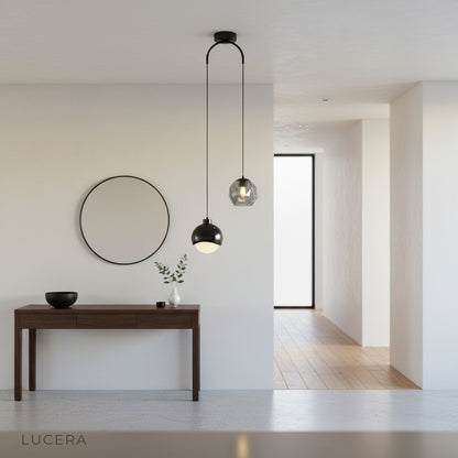 Vale pendant light by Lucera casting a warm glow over a chic lounge area at dusk