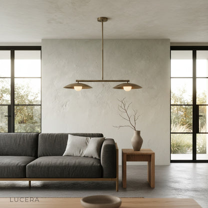 Nighttime ambient shot of the Lucera pendant light with dimmed bulbs in a serene bedroom corner