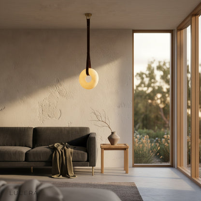 nighttime ambient view of Butte Alabaster pendant light in hallway with stone accents
