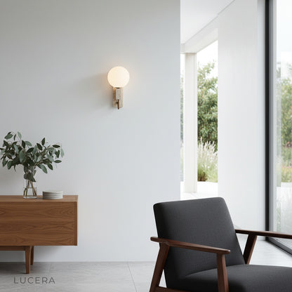 contemporary travertine wall sconce illuminated in minimalist living room at dusk