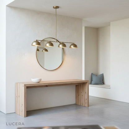 Nighttime lifestyle shot of Lucera Ursule linear pendant light in elegant dining space