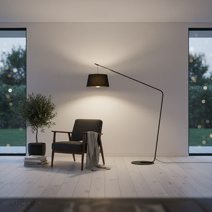 ambient nighttime shot of curved stem floor lamp with soft light in modern hallway